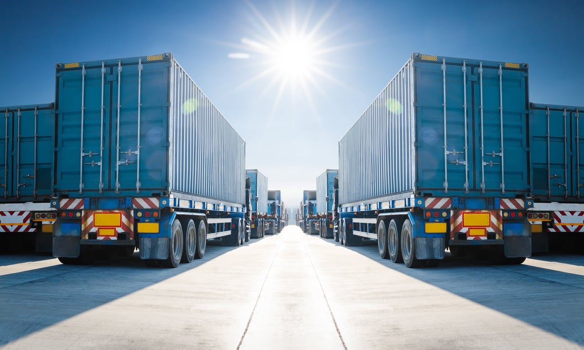 Many Semi Trailer Trucks on The Parking Lot at The Port. Big Rig. Economy Business Transport on Road. Shipping Container Import- Export. Warehouse Port. Trucking. Freight Logistics Transportation.