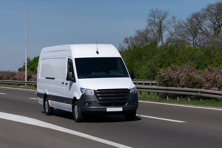 White electric delivery van on the road