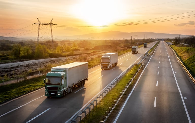 Convoy of green trucks with grey containers on a highway, cargo transportation concept - freight service